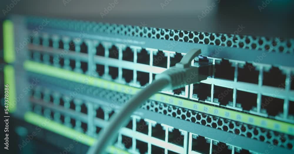 Poster ethernet cable is plugged into the port of network internet switch