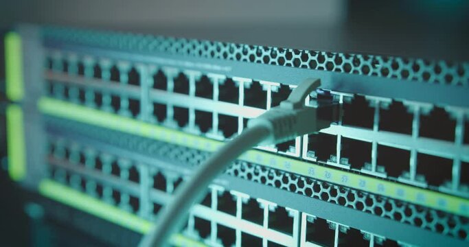 Ethernet cable is plugged into the port of network internet switch