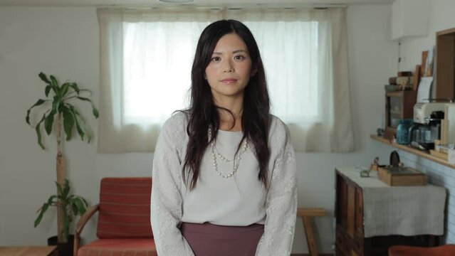 Beautiful Japanese woman opens her eyes and stares the camera. Emotionless, Still, Protest. Living room. 25P