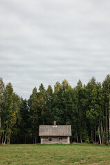 Traditional Latvian bath house in front of a forest