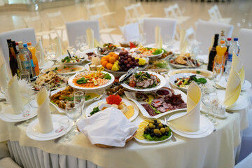 Beautifully served banquet table with a variety of snacks at corporate dinner, birthday party, Christmas party or wedding celebration.