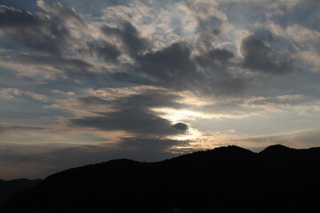 Sunset with clouds and mountains
