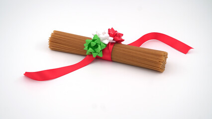 Spaghetti with red ribbon and colors of Italy's flag on an isolated background