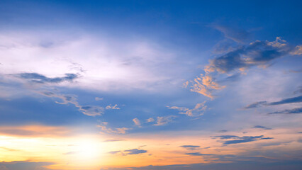 Naklejka na ściany i meble Sunset sky clouds with yellow sunlight on blue sky background in evening time