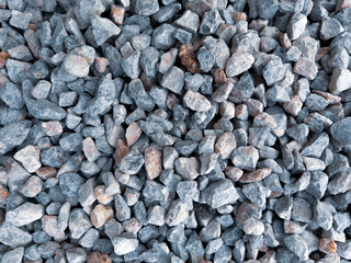 Isolated many crushed stone ground floor background. Close up granite gravel texture in natural light