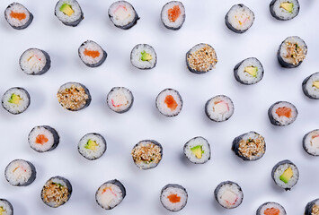 Many sushi maki rolls background on white background