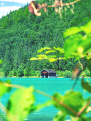 Fisher boat house and wooden hut with pier in the shore of Walchensee lake