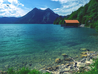 Walchensee cottage with boat house against the Alps peaks