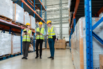 Warehouse worker taking package in the shelf in a large warehouse in a large warehouse