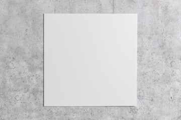 Square sheet of paper on the concrete background.