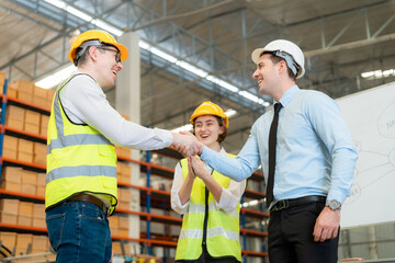 Group of industry workers stacks hands to motivation