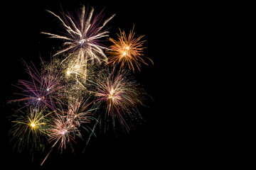 Colored fireworks on black background copy space