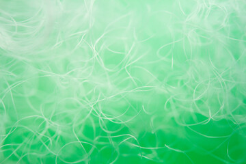 Extreme macro of polyester stable fiber on green background