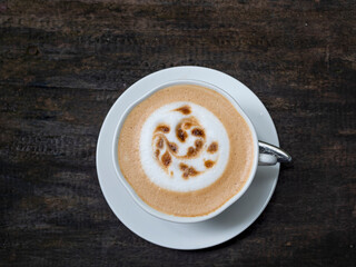 Hot caramel coffee in a white cup