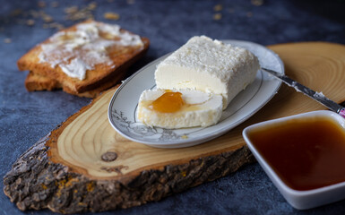 Clotted cream (butter cream) for Turkish breakfast - Kaymak, honey and glass of milk