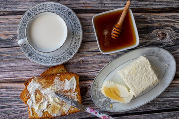 Clotted cream (butter cream) for Turkish breakfast - Kaymak, honey and glass of milk