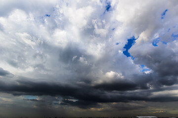 The dark sky with heavy clouds converging and a violent storm before the rain.Bad or moody weather...