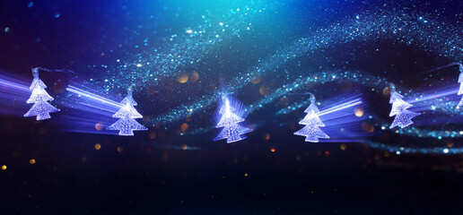 Christmas tree garland lights over dark background with glitter overlay