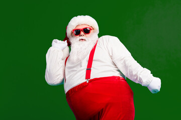 Fototapeta na wymiar Photo of funky cool santa claus dance x-mas christmas newyear jolly discotheque wear headwear suspenders overall sunglass isolated over blue color background
