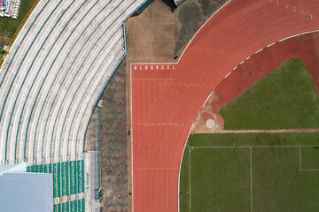 Aerial view of empty soccer field from above with running tracks around it Amazing stadium for many...