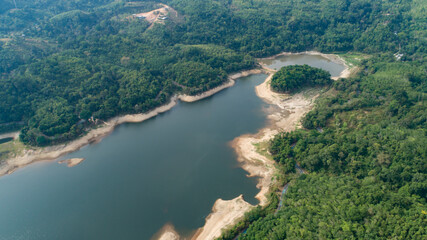 Obraz na płótnie Canvas Top down from Drone aerial view of rainforest with asphalt road around the dam