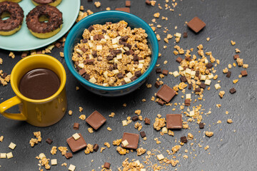 Chocolate granola muesli with chocolate milk,almonds, hazelnuts  and doughnuts