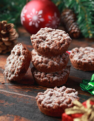 Christmas chocolate mince pies with decoration, gifts, green tree branch on wooden rustic table