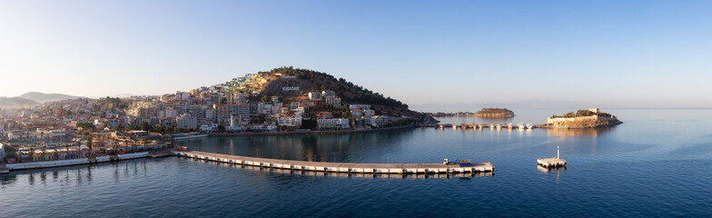 Homes and Buildings in a Touristic Town by the Aegean Sea. Kusadasi, Turkey. Sunny Morning Sunrise. Panoramic Aerial View from Cruise Ship