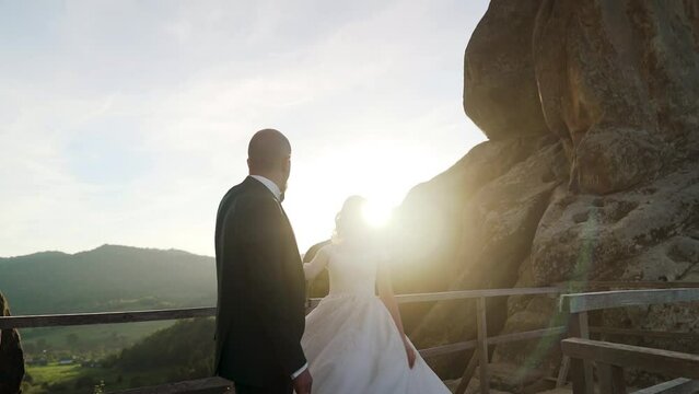 They hugging each other and feeling romantic together background cliff and rocks