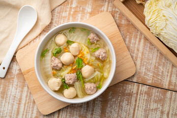 Chinese Cabbage Soup with Minced Pork and meatball in white bowl.Thai style clear soup.Top view