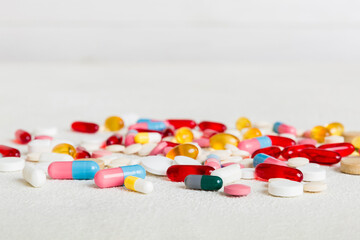 Many different colorful medication and pills perspective view. Set of many pills on colored...