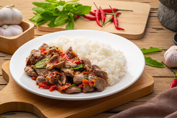 Stir-fried Chicken Giblets(livers, heart and gizzards) with Chillies and basil in white plate with...