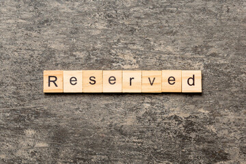 reserved word written on wood block. reserved text on cement table for your desing, concept