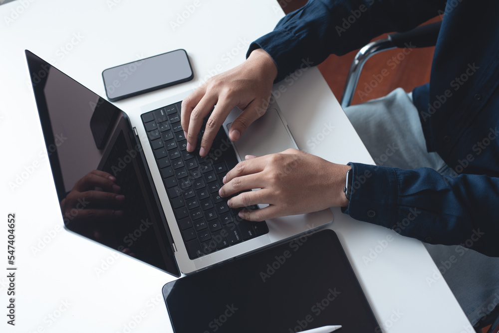 Poster business man working on laptop computer, typing on keyboard with digital tablet and mobile phone on 