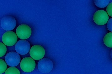 Abstract colored balls background. Multi-colored taw toy scattered on bright paper. Base for design nice backdrop, wallpaper, poster. Noisy surface texture