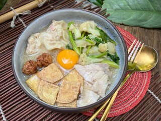 Soup in gravy with yolk, tofu and vegetable