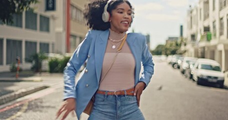 Music, street and black woman dance with energy, wellness and freedom while streaming rap, hip hop or radio sound. Headphones, crazy fun and retro dancer listening to audio song while dancing in city