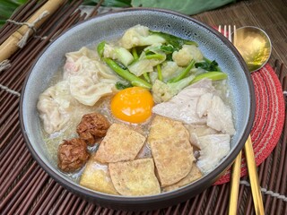 Soup in gravy with yolk, tofu and vegetable