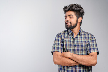 Young Indian businessman against white background
