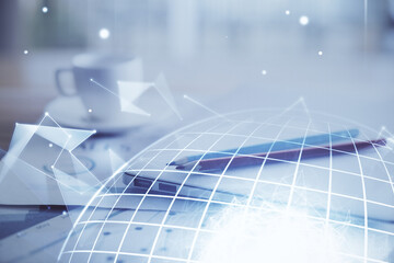 Double exposure of desktop with computer and world map hologram. International data network concept.
