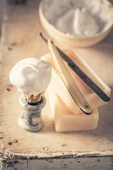 Antique and traditional barber equipment with razor and brush.