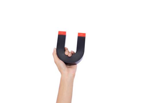 Hand holding a magnet isolated on white background. attracting money concept