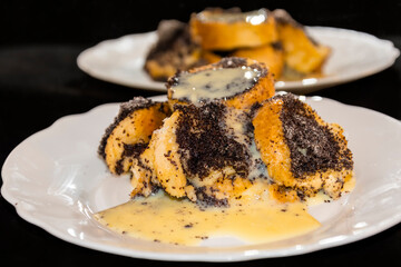 Poppy seed bread pudding on a white plate