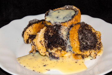 Poppy seed bread pudding on a white plate