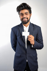 young indian Business man handing a blank business card Isolated on white.