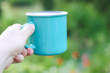 Hot herbal tea in teacup outdoors