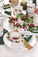 Christmas table setting in white green red colors