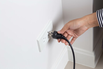 Unplug or plugged in concept in the wall-mounted electrical out