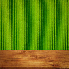 The background is blank wooden boards and a textured striped wall with gradient lighting and...