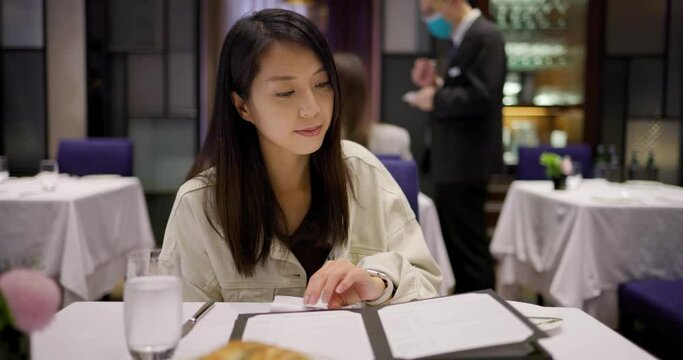 Woman look at the menu in restaurant